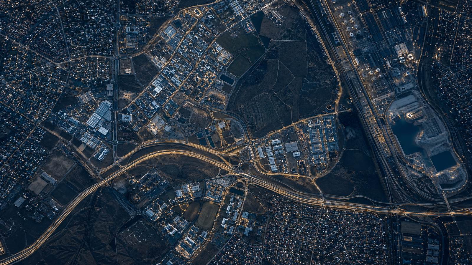 Aerial night view of a South African city showing road networks, industrial land and residential settlement patterns